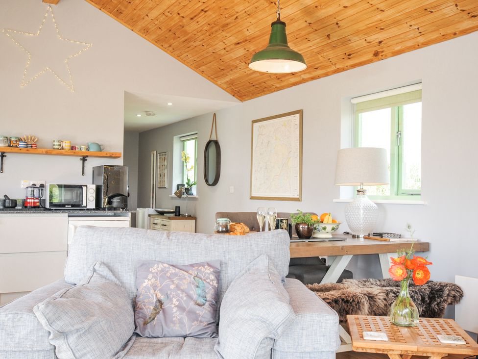 A living room with a sofa and table at Smugglers, Bodmin Moor, St Breward near St Tudy