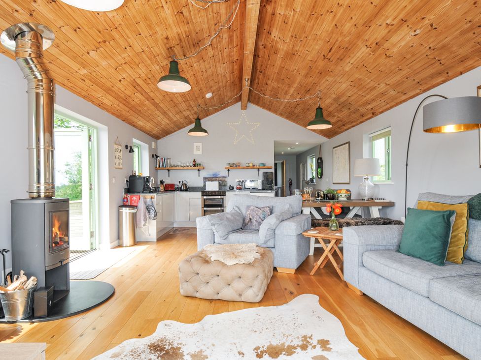 A living room with a sofa and a fireplace at Smugglers Bodmin Moor, St Breward near St Tudy