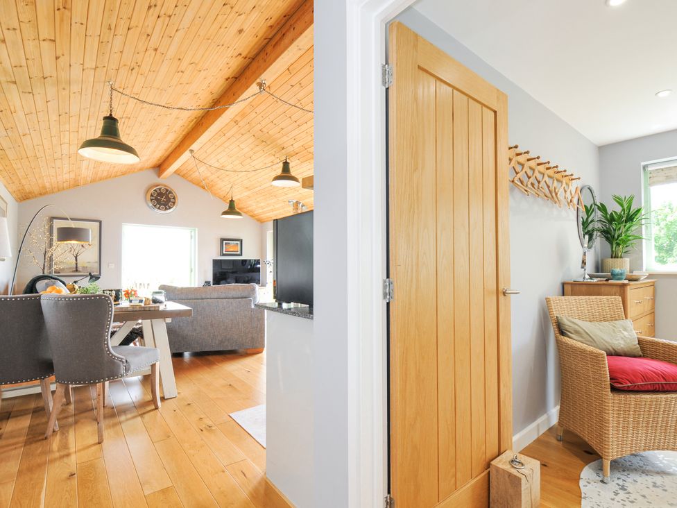A living room with a dining area and a door at Smugglers, Bodmin Moor, St Breward near St Tudy