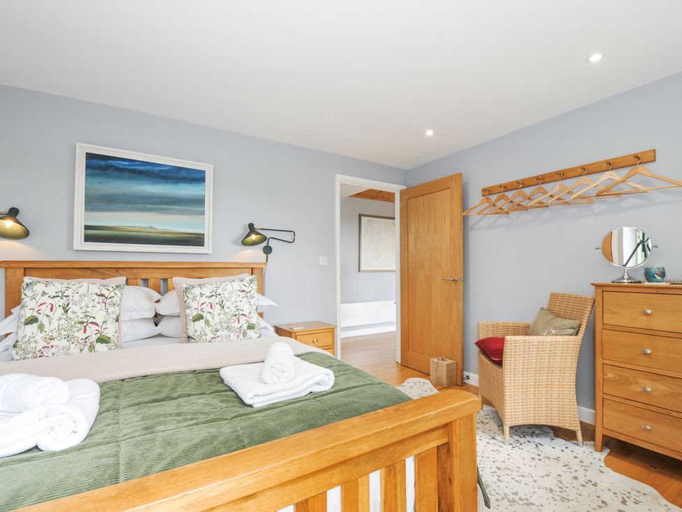 A bedroom with a wooden bed and wardrobe at Smugglers Bodmin Moor, St Breward near St Tudy