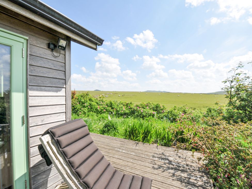 An outdoor area with a chair overlooking a landscape at Smugglers Bodmin Moor, St Breward near St Tudy