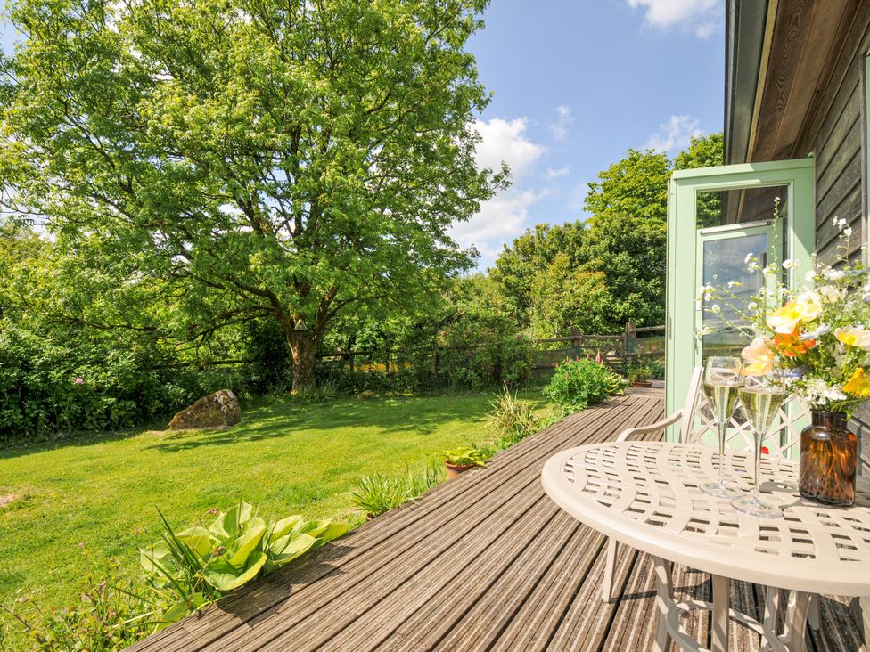 An outdoor space with a table and chairs near a tree at Smugglers Bodmin Moor, St Breward near St Tudy