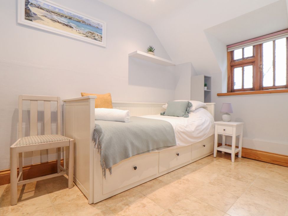 A bedroom with a daybed chair nightstand and window at Splatt Barn in Rock