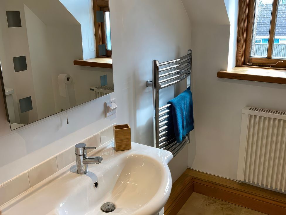 A bathroom with a sink and mirror at Splatt Barn in Rock