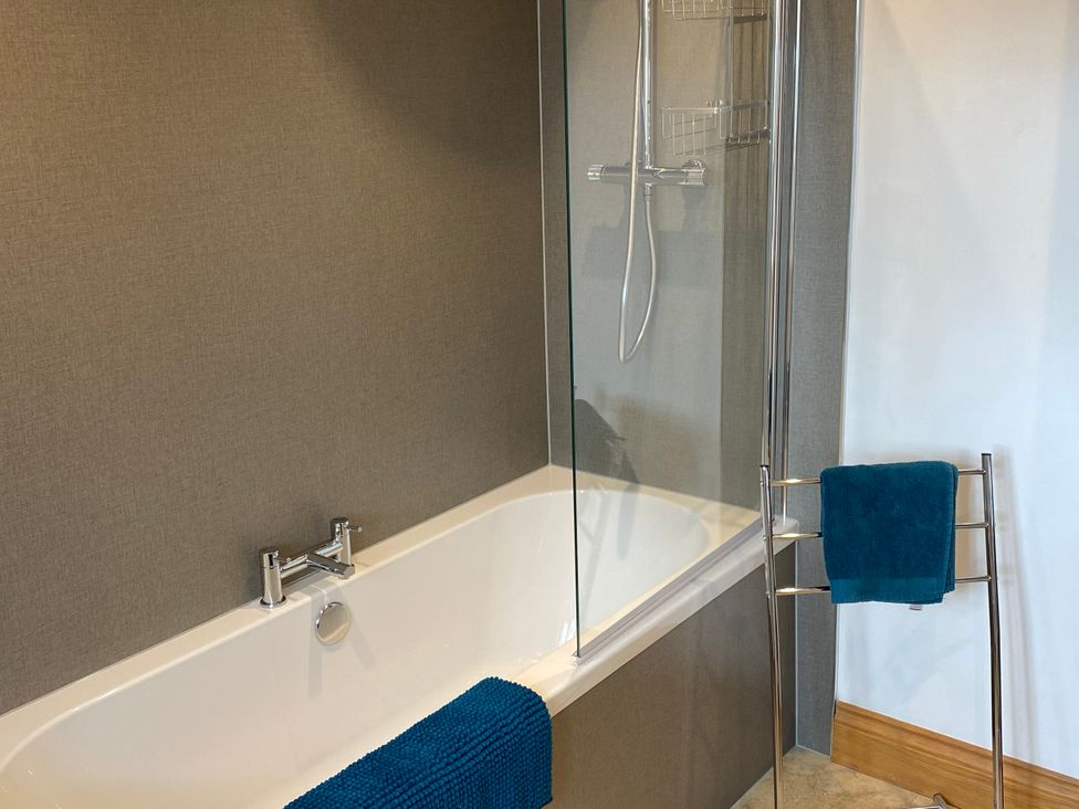 A bathroom with a bathtub and shower at Splatt Barn in Rock