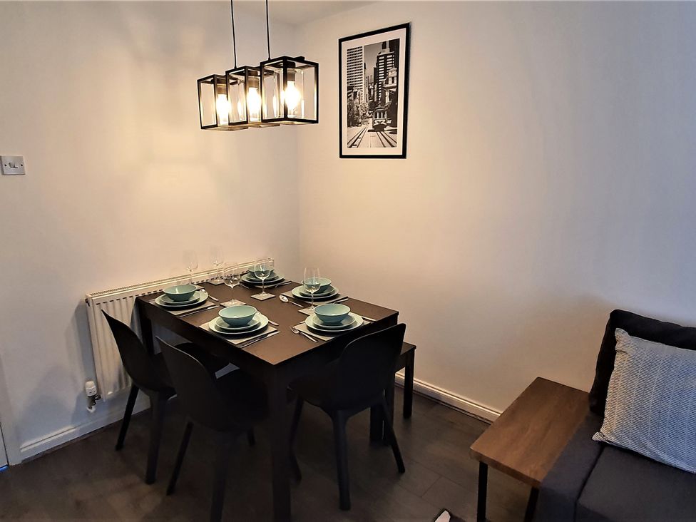 A dining room with a table set for dinner at 32 Moorland House
