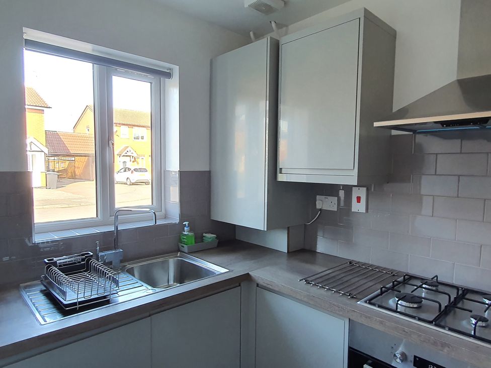 A kitchen with a sink and cabinets at 32 Moorland House
