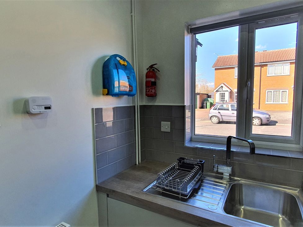 A kitchen with a sink and window at 32 Moorland House