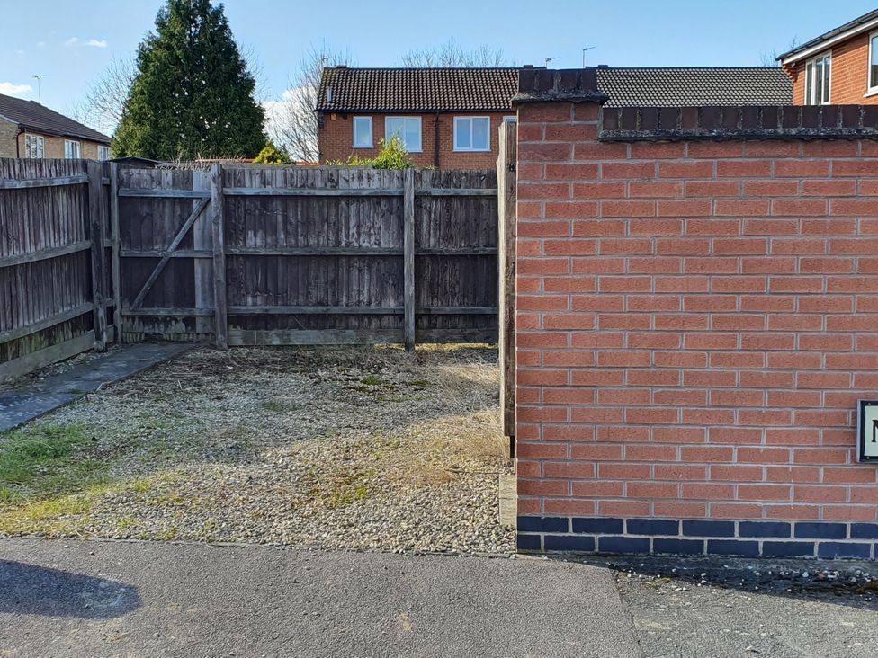 A view of a fenced outdoor area with a brick wall at 32 Moorland House 