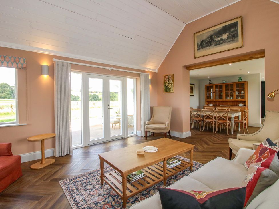 A living room with a sofa and coffee table at Hoddell Pitch Cottage in Kinnerton near New Radnor