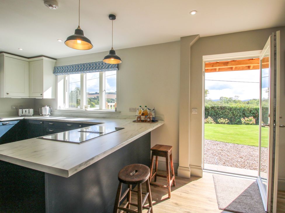 A kitchen with a window and counter at Hoddell Pitch Cottage Kinnerton near New Radnor