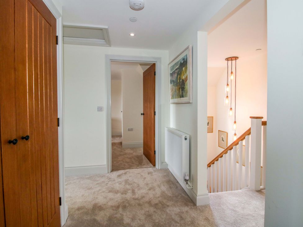 A hallway with doors and stairs at Hoddell Pitch Cottage in Kinnerton near New Radnor