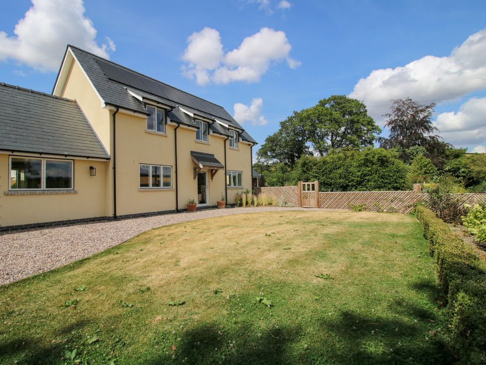 A house with a garden and fence at Hoddell Pitch Cottage Kinnerton near New Radnor