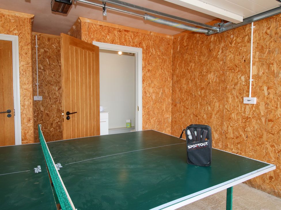 A game room with a table tennis table and doors at Hoddell Pitch Cottage in Kinnerton near New Radnor