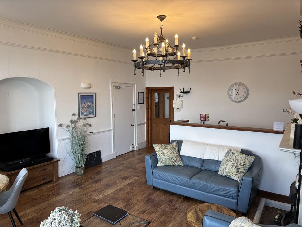 A living room with a sofa and television at Bayview Tower in Lynton