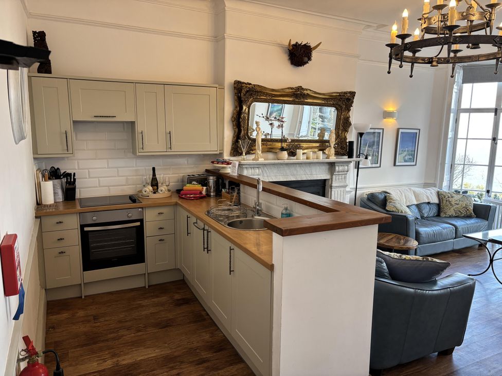 A kitchen with an open layout and a living area at Bayview Tower in Lynton