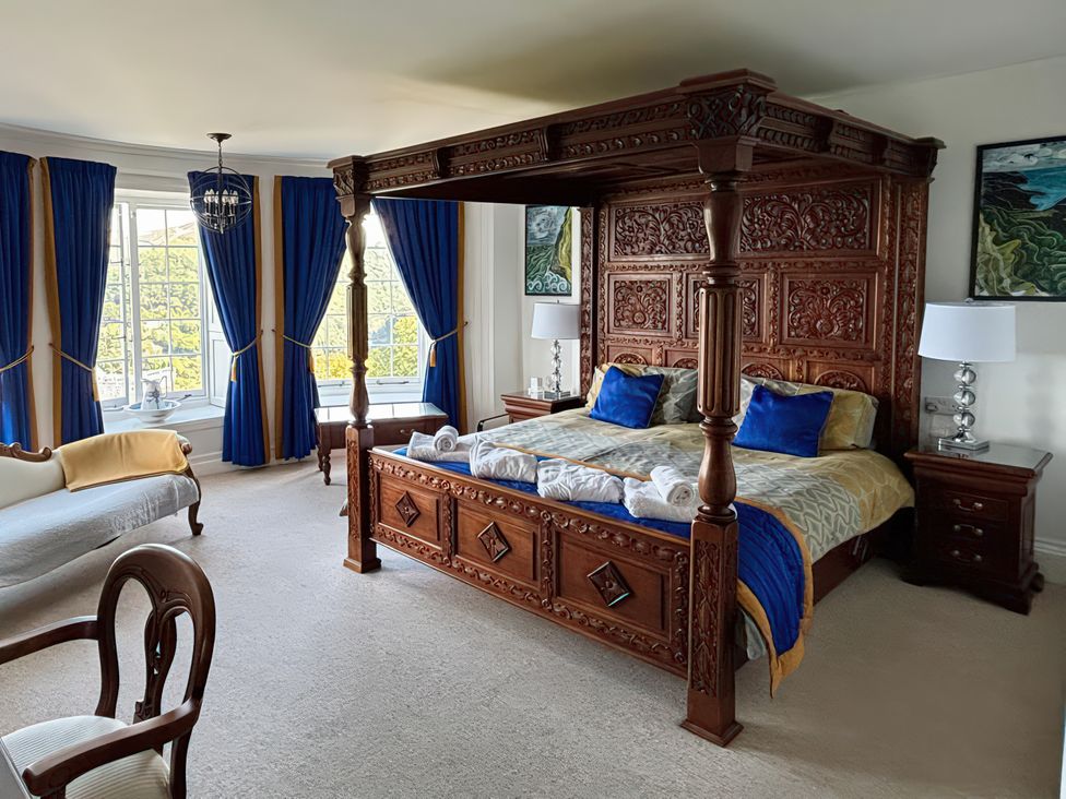A bedroom with a four-poster bed and furniture at Bayview Tower in Lynton