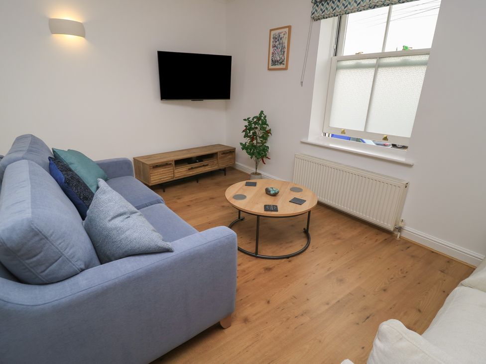 A living room with a sofa and television at Weyside in Weymouth