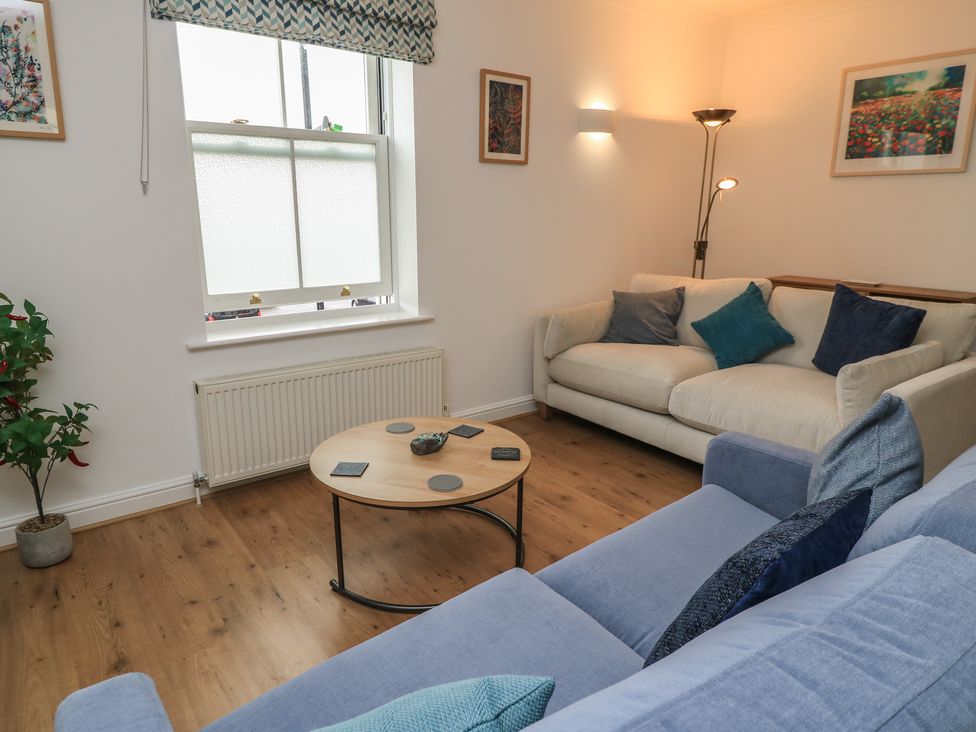 A living room with a coffee table and sofa at Weyside in Weymouth