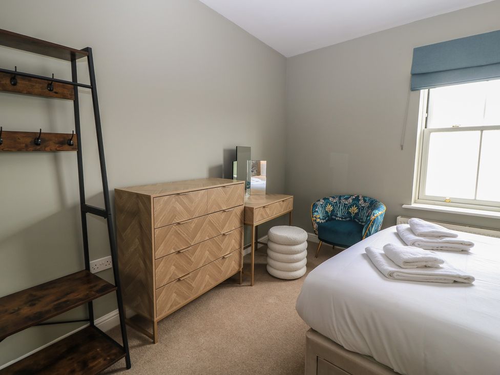 A bedroom with a bed and shelving at Weyside in Weymouth