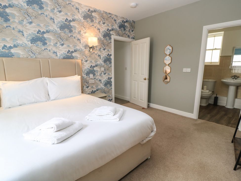 A bedroom with a bed and towels at Weyside in Weymouth