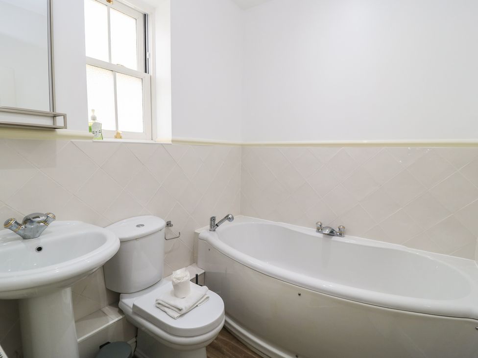 A bathroom with a bathtub, sink, and toilet at Weyside in Weymouth