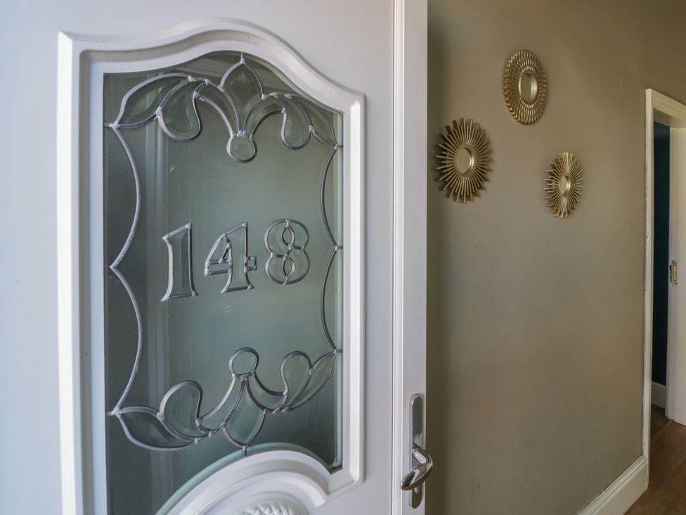 An entryway showing a door with number 148 and decorative mirrors at Cosy Escape in Birmingham