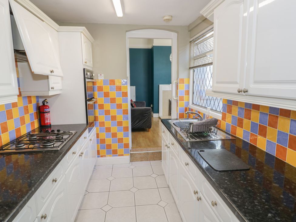 A kitchen with appliances and tiles at Cosy Escape in Birmingham