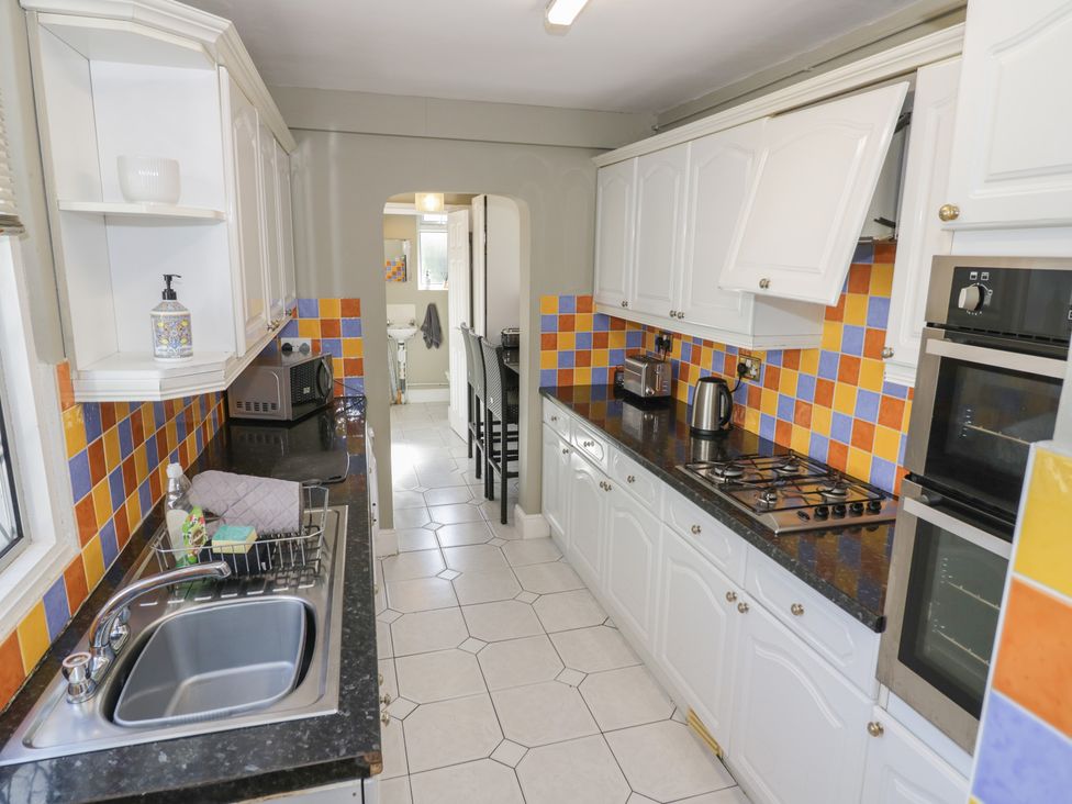 A kitchen with a sink and appliances at Cosy Escape in Birmingham