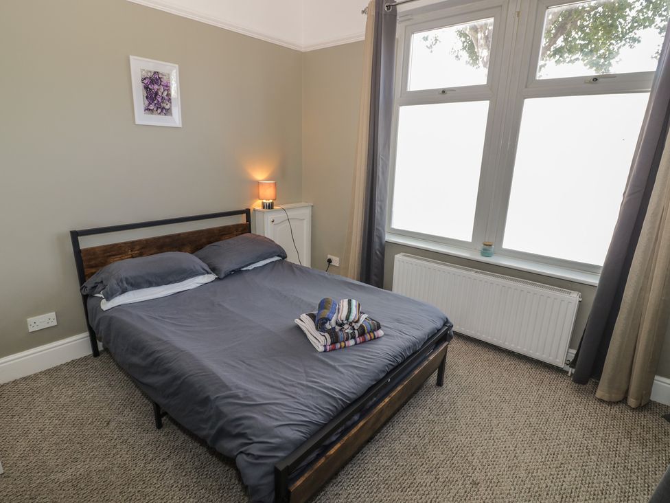 A bedroom with a bed and large windows at Cosy Escape Birmingham