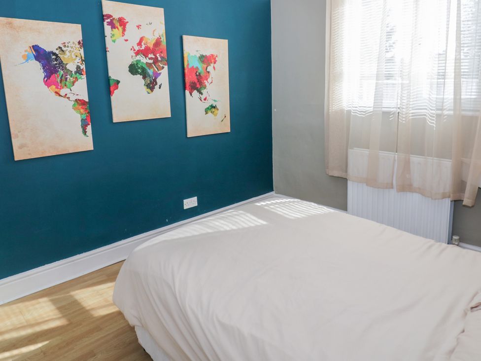 A bedroom with a bed and map art on the wall at Cosy Escape, Birmingham