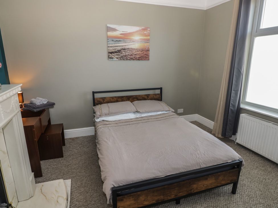 A bedroom with a bed and nightstand at Cosy Escape in Birmingham