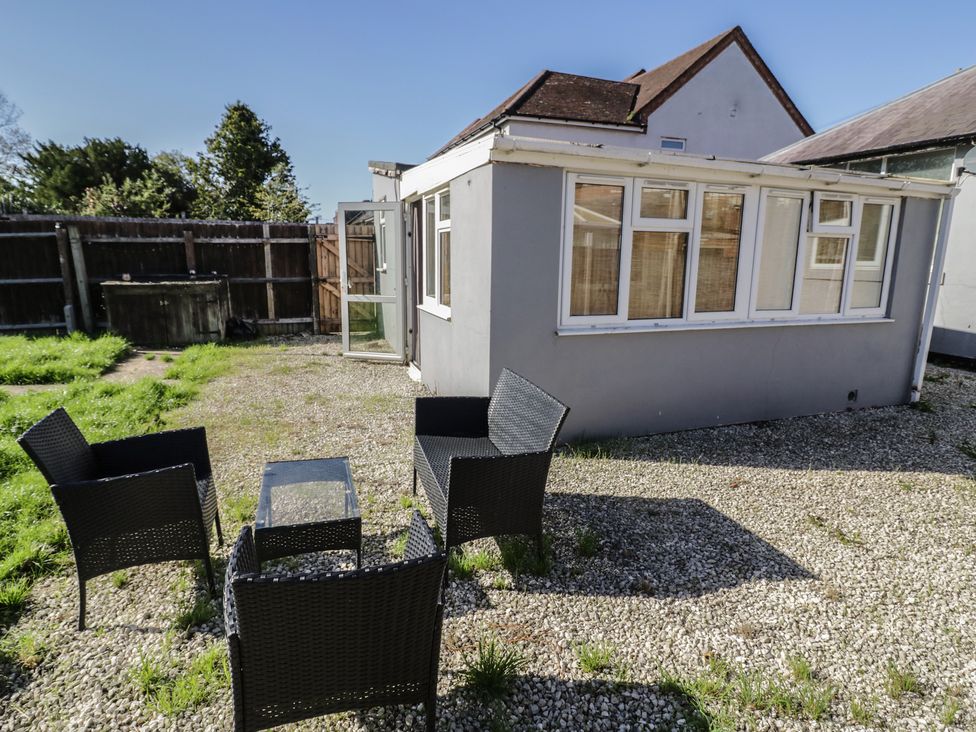 An outdoor area with seating and a small table at Cosy Escape in Birmingham