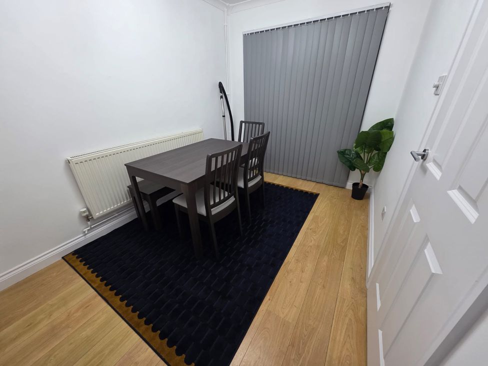 A dining room with a table and chairs at 12 Gorse Lane, Leicester