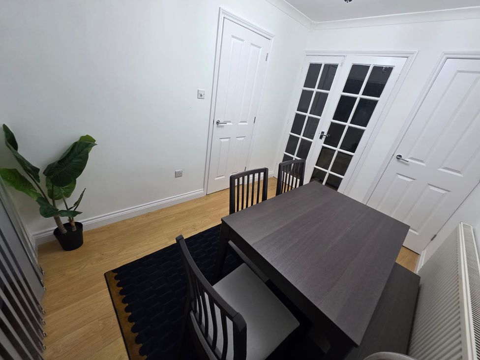 A dining room with a table and chairs at 12 Gorse Lane Leicester