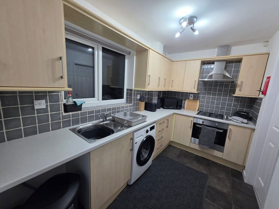 A kitchen with a sink and appliances at 12 Gorse Lane Leicester