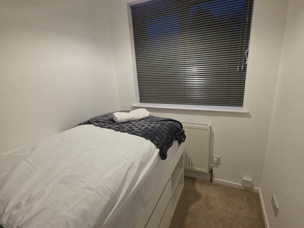A bedroom with a bed and window at 12 Gorse Lane in Leicester