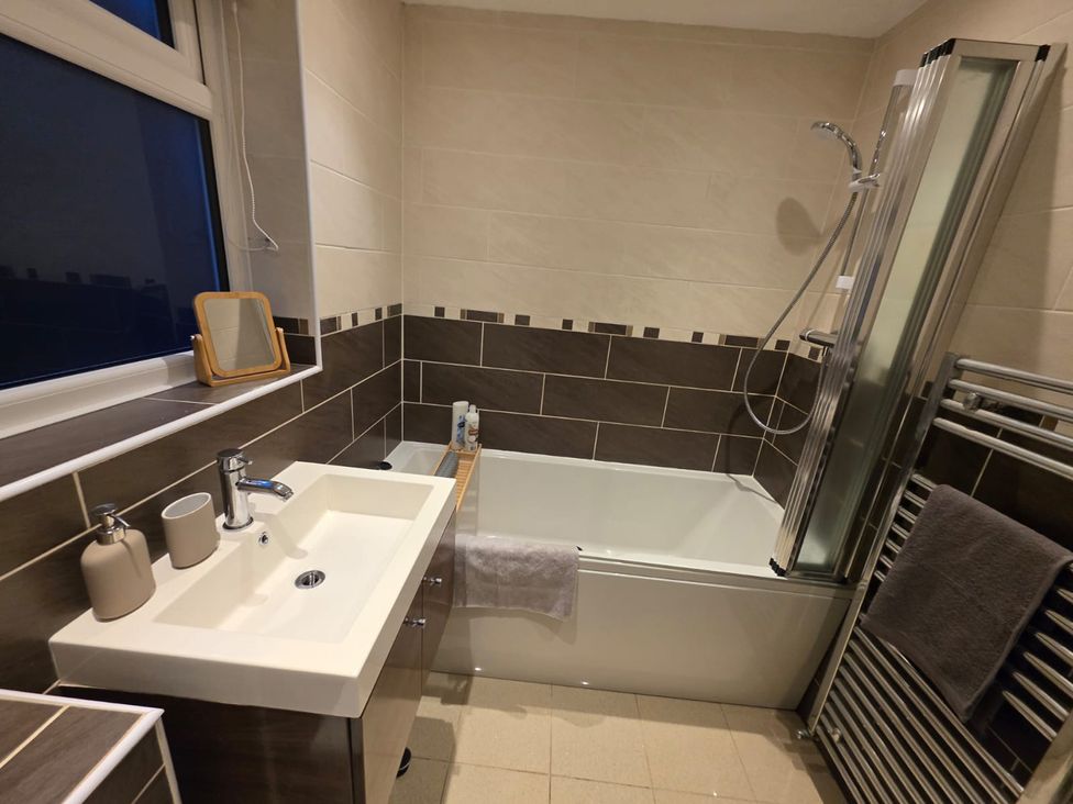 A bathroom with a sink, bathtub, and shower at 12 Gorse Lane in Leicester