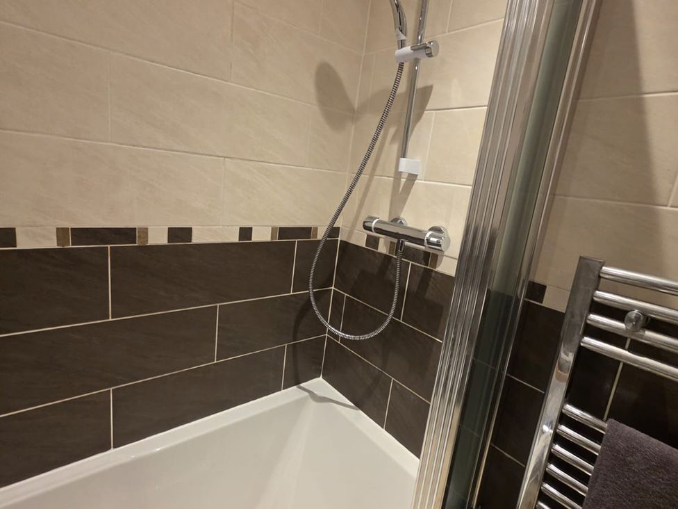 A bathroom featuring a shower and bathtub at 12 Gorse Lane Leicester