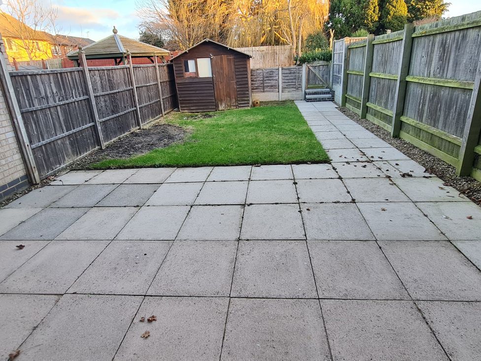 A garden with a shed and patio at 12 Gorse Lane in Leicester