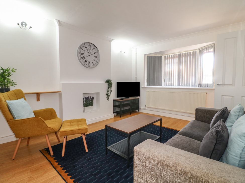 A living room with a sofa and a coffee table at 12 Gorse Lane Syston