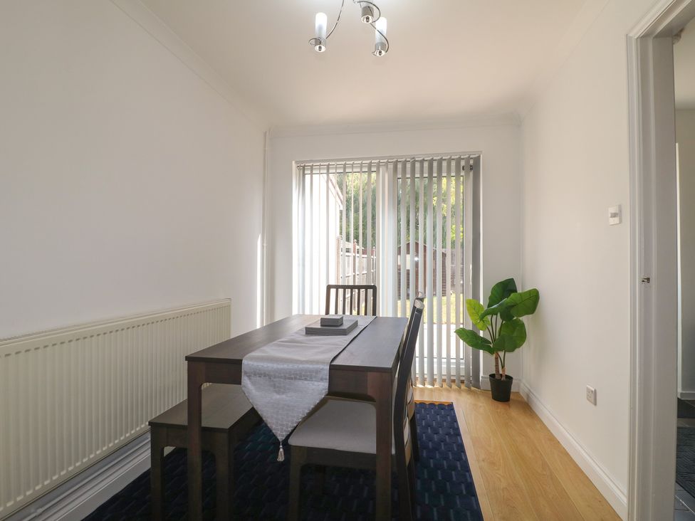 A dining room with a table and chairs at 12 Gorse Lane in Syston