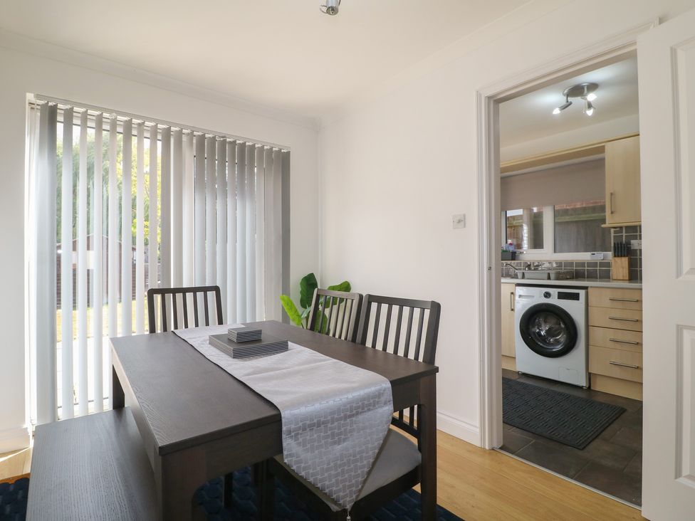 A dining room with a table and chairs at 12 Gorse Lane in Syston
