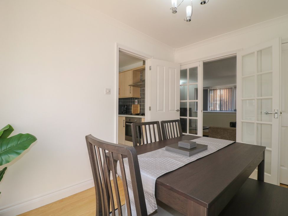 A dining room with a table and chairs at 12 Gorse Lane in Syston