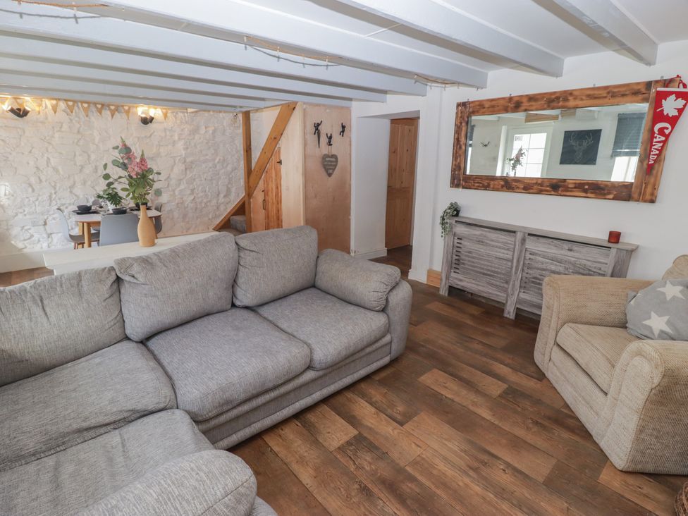 A living room with a sofa and armchair at 41 St. James Street Narberth