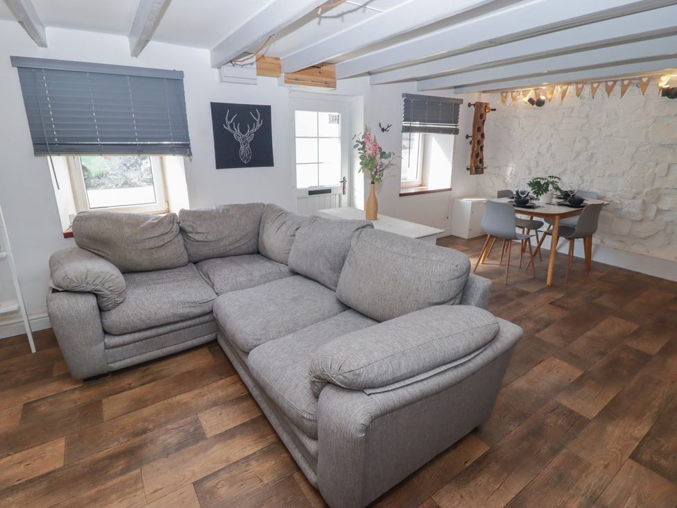 A living room with a sofa and dining area at 41 St. James Street Narberth
