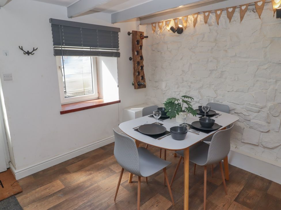 A dining room with a table set for meals at 41 St. James Street Narberth