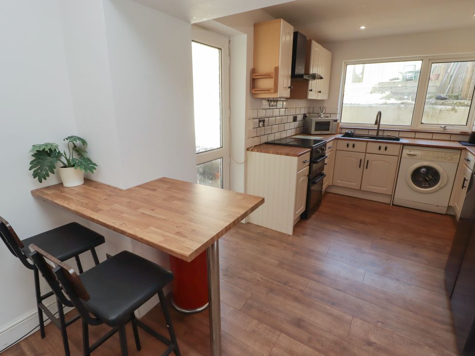 A kitchen with appliances and a table at 41 St. James Street Narberth