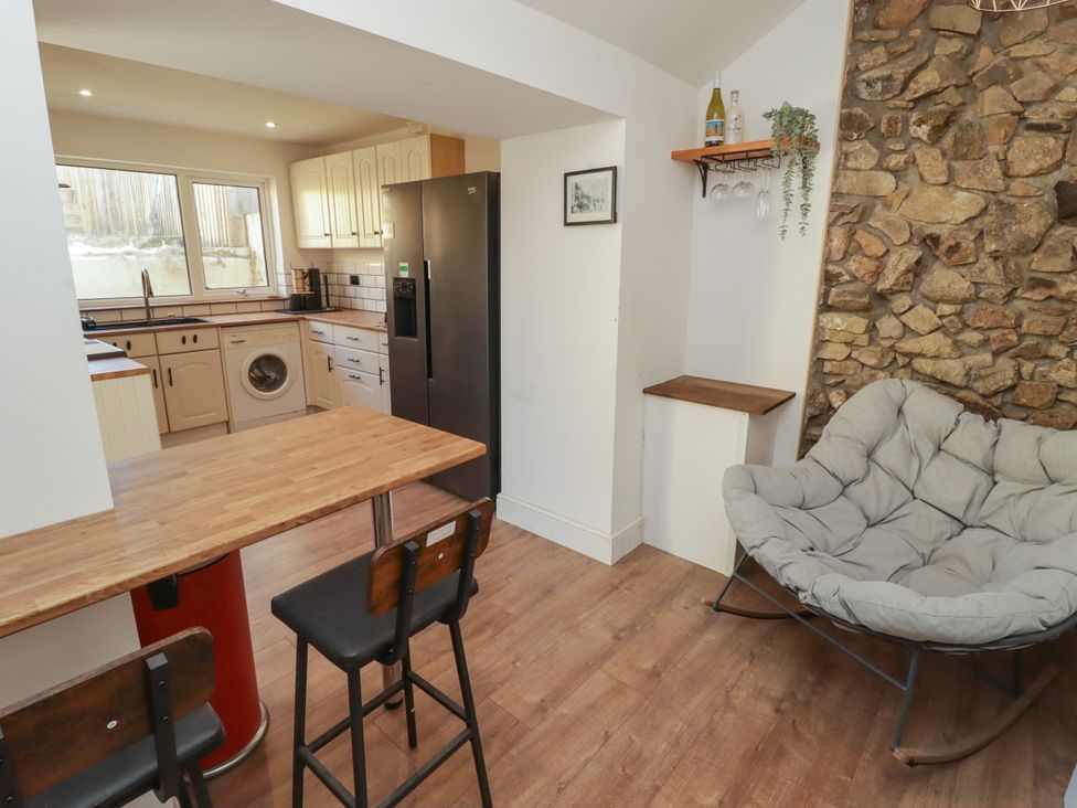 A kitchen with appliances and a table at 41 St. James Street in Narberth