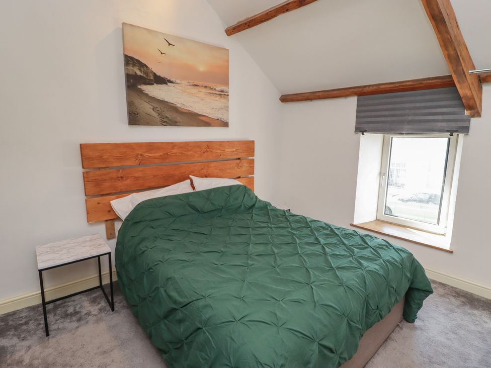 A bedroom with a bed and bedside table at 41 St. James Street in Narberth